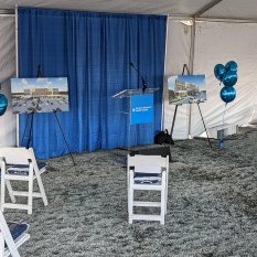 Groundbreaking ceremony setup with lectern, and chairs